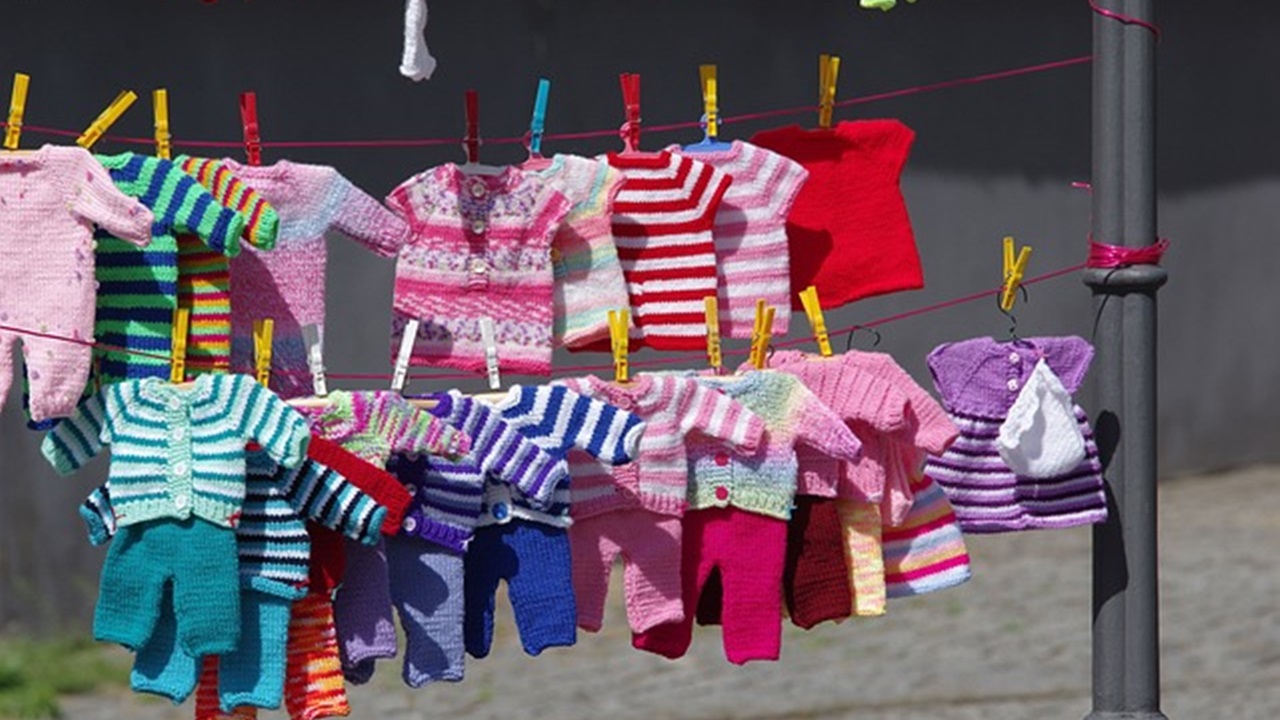 displaying children clothes hanging on a rope