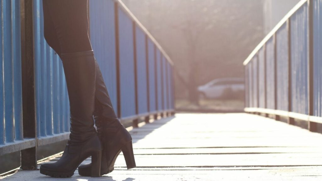 a girl is standing on the bridge